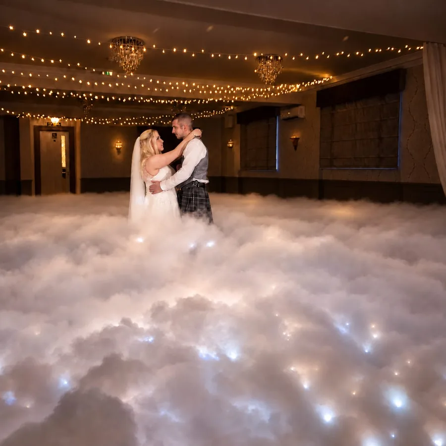 Bride and groom first dance on a cloud of dry ice