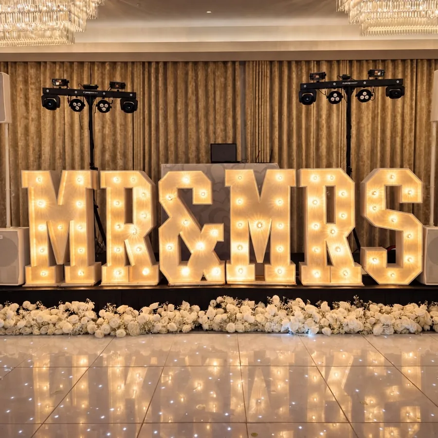 Illuminated MR&MRS letters in front of the DJ setup